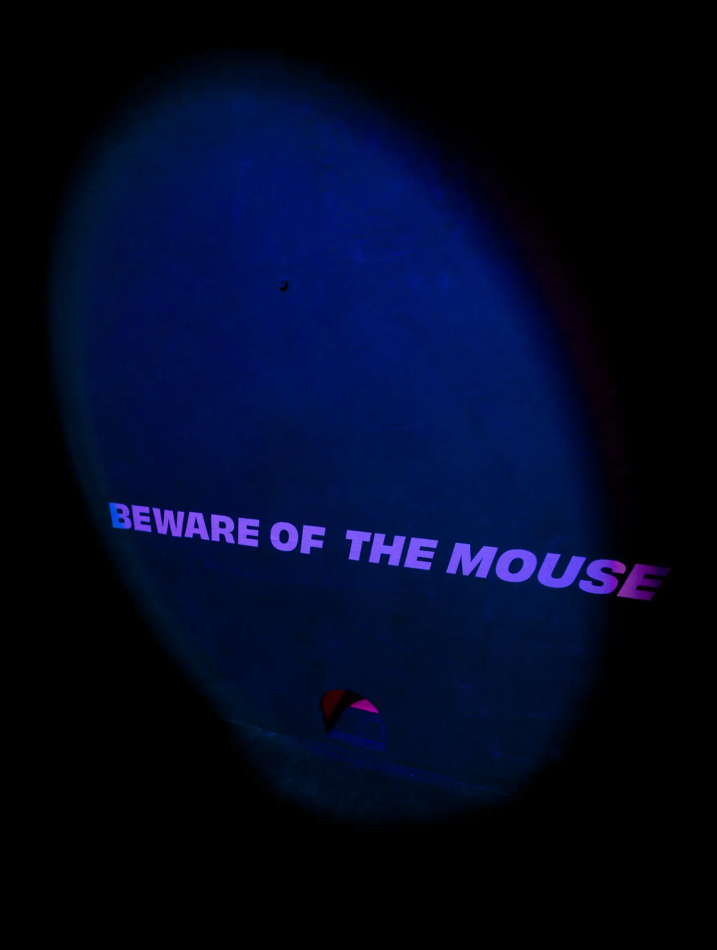 Visitor in conversation with an embodied AI character while responsive lighting shifts around the installation