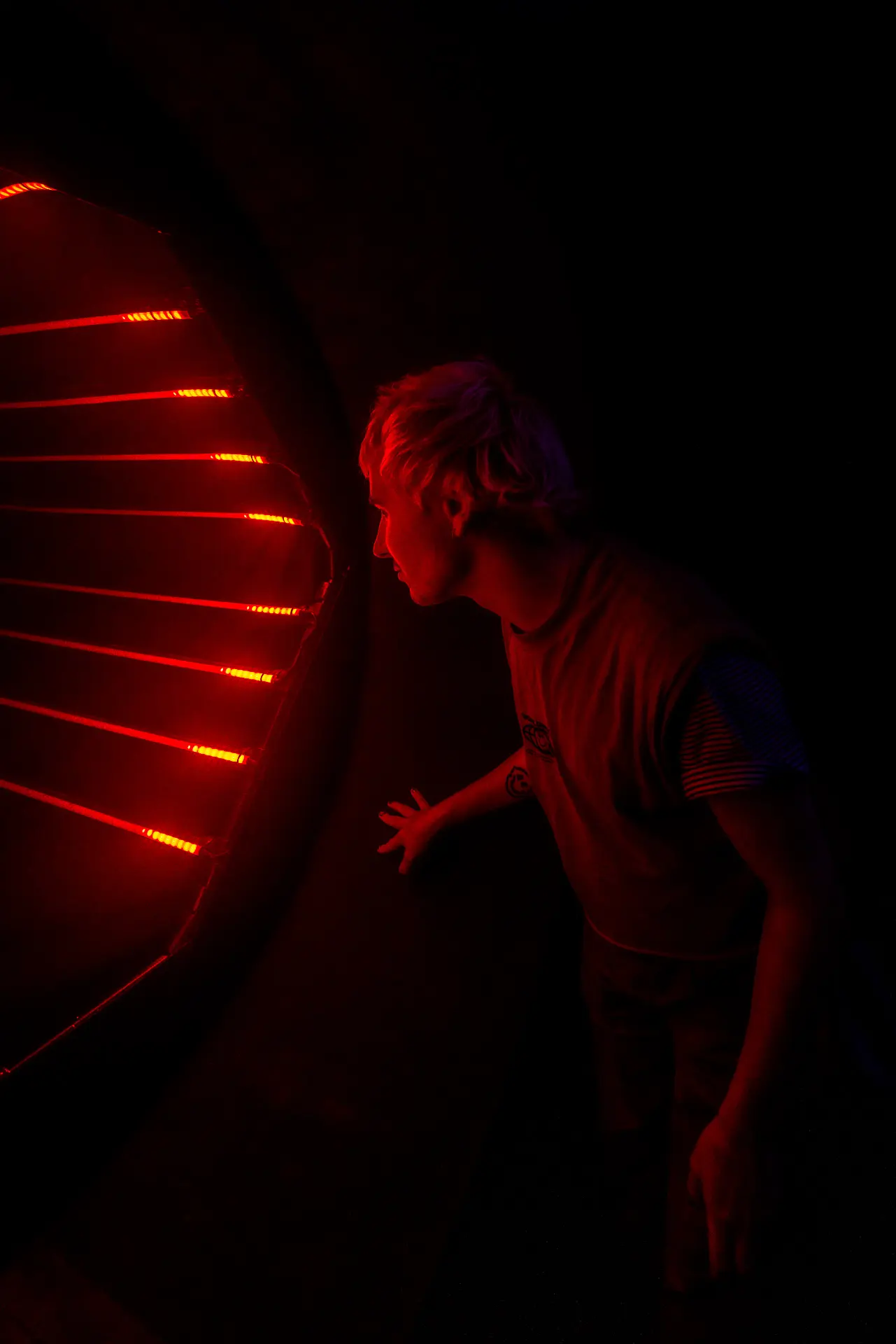 Participant speaking directly to the AI interface framed by a glowing red circular portal